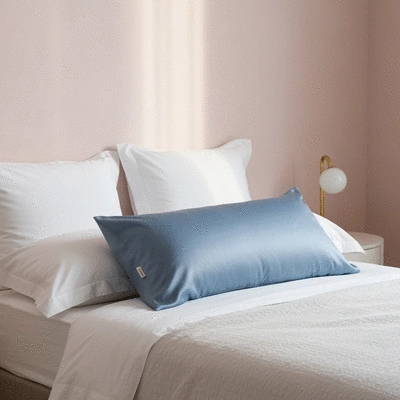 Luxurious mulberry silk pillowcase on a bed